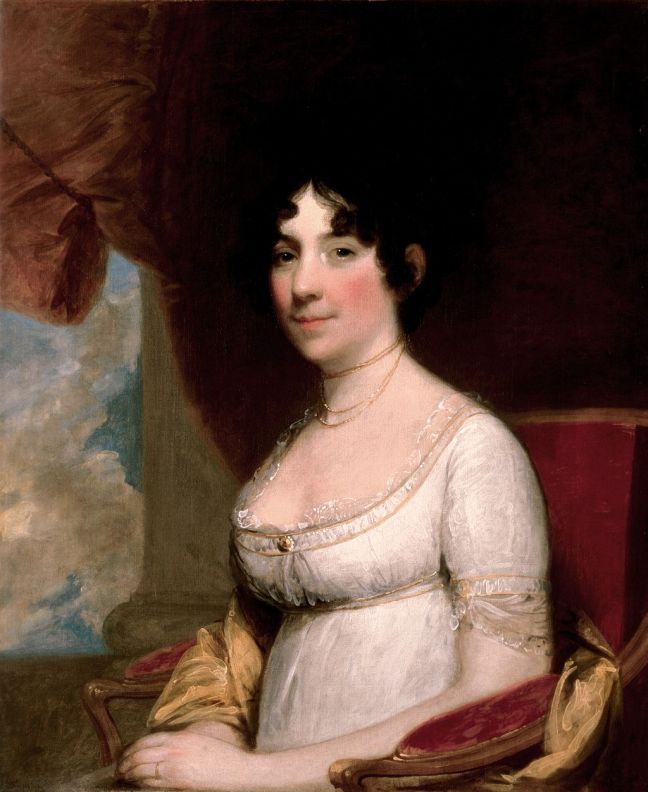 Historical image of Dolley Madison. Dark curly hair, pale complexion with rosey cheeks, white dress.